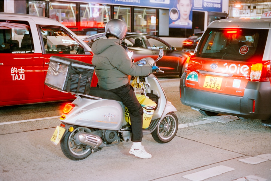 Person on scooter in traffic at night