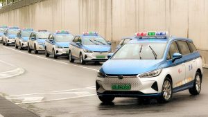 a line of police cars on a city street